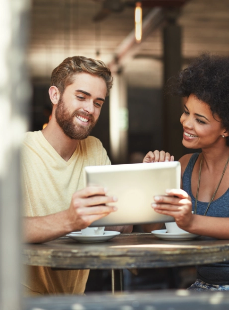 A man and woman receiving top-notch hospital care while looking at a tablet together